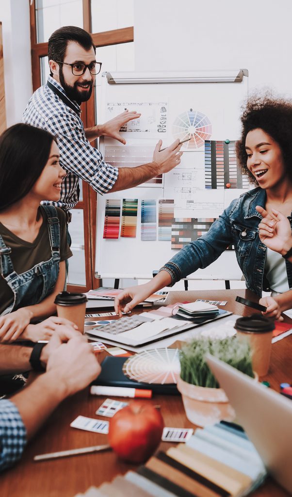 Presentation. Show. White Board. Design Studio. Multi-Ethnic. Project. Creative. Look. People. Designers. Young Specialists. Choose Colors for Design. Teamwork. Discussion. Brainstorming. Workplace.