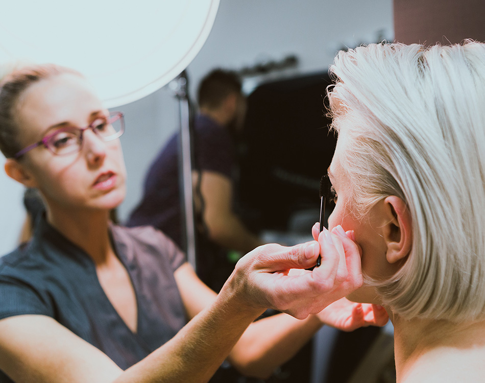 A stylist making finishing touches for a photo shoot.